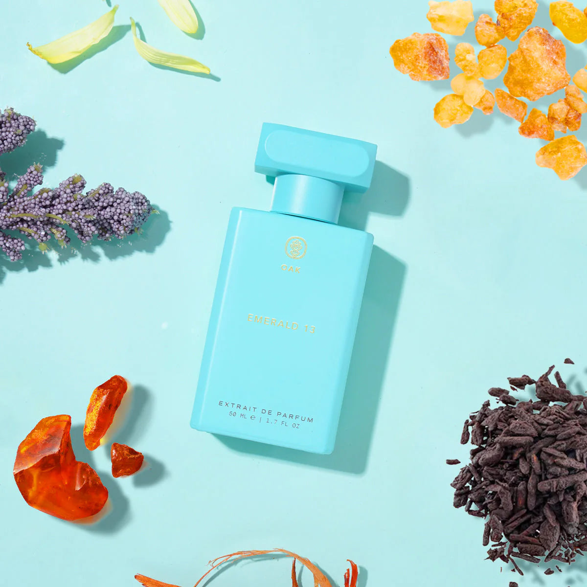 a bottle of perfume sitting on top of a blue table