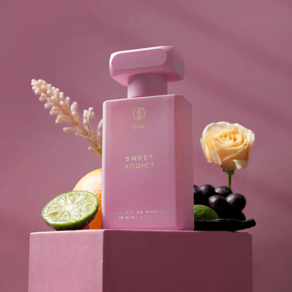 a bottle of perfume sitting on top of a pink box