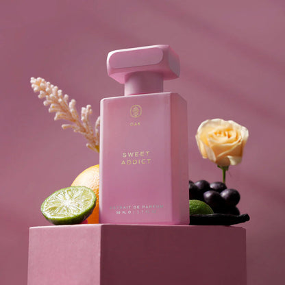 a bottle of perfume sitting on top of a pink box