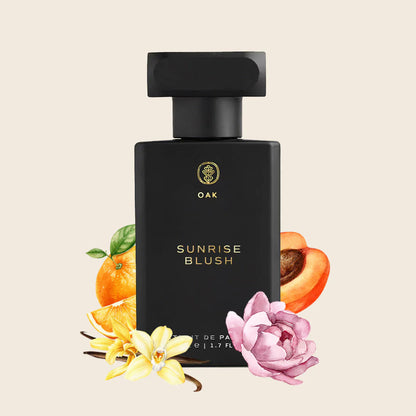 a bottle of sunrise blush perfume surrounded by flowers