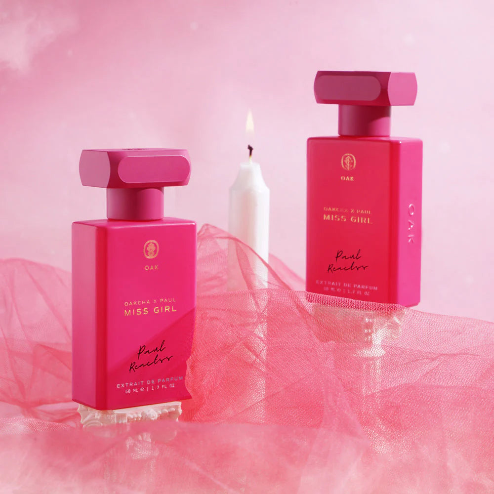 two bottles of perfume on a pink background