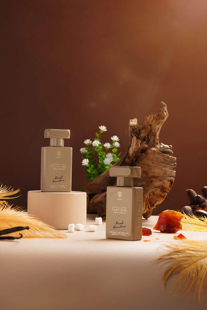 a table topped with bottles of perfume next to a potted plant