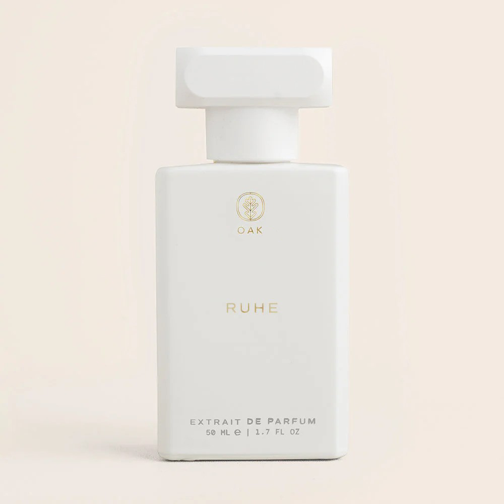 a bottle of perfume sitting on a white surface