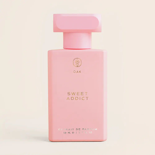 a bottle of pink perfume on a white background
