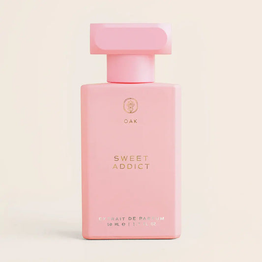 a bottle of pink perfume on a white background