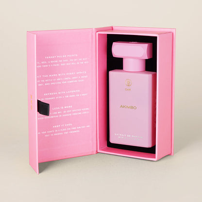 a bottle of pink perfume in a pink box