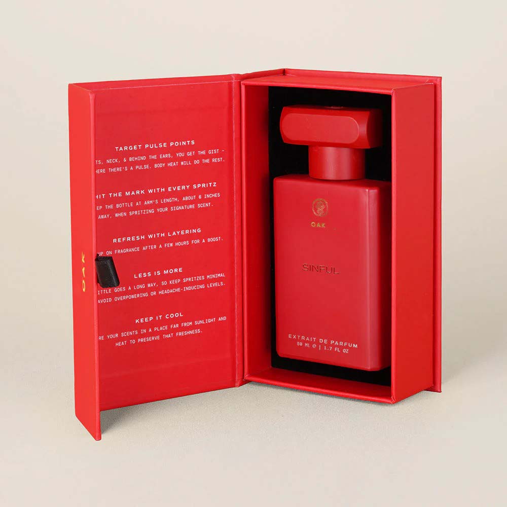 a red bottle in a red box on a white surface