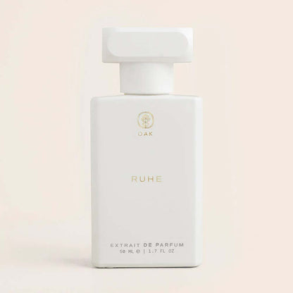 a bottle of perfume sitting on a white surface