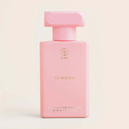 a bottle of pink perfume on a white background