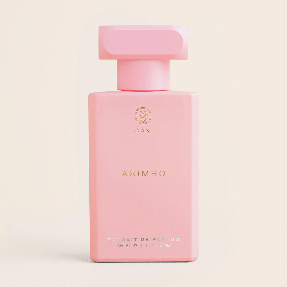 a bottle of pink perfume on a white background